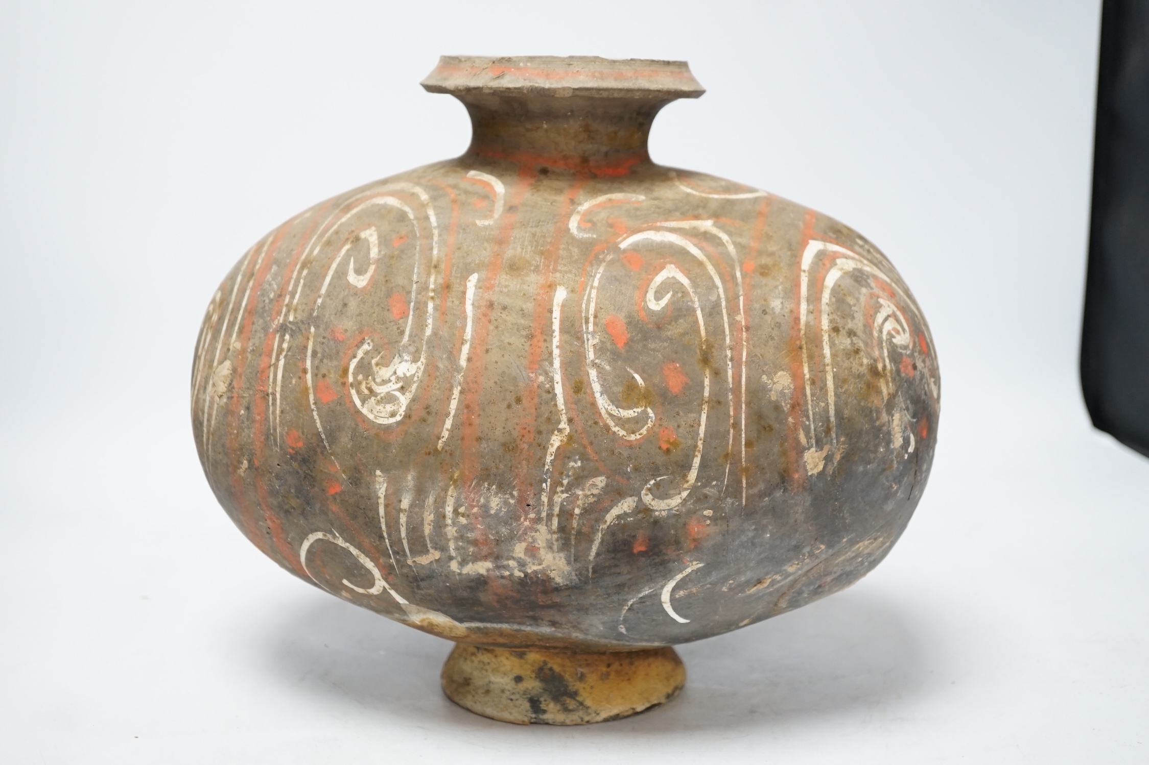 A Chinese pigment painted 'cocoon' jar, Han dynasty, 26cm high